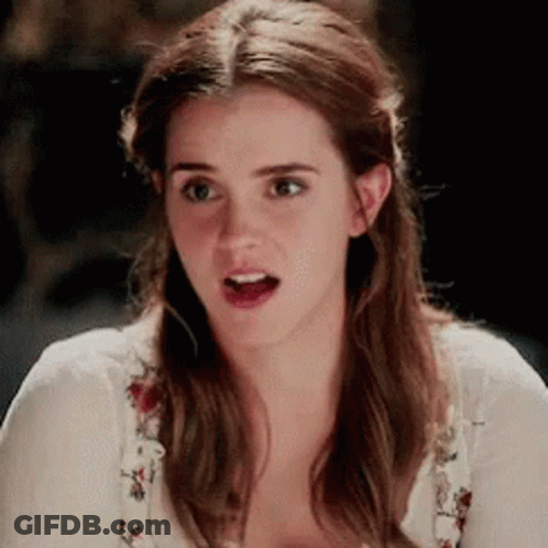 A Close Up Of A Woman Making A Surprised Face While Wearing A White Shirt . GIF