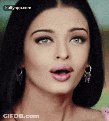 A Close Up Of A Woman Making A Surprised Face With Her Mouth Open . GIF