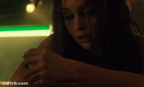 A Close Up Of A Woman 'S Arm With A Green Light Behind Her GIF