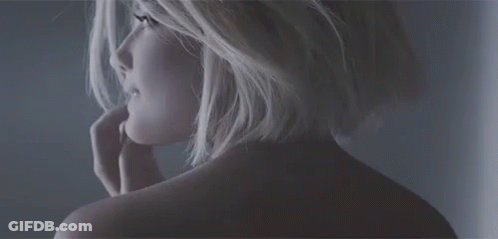 A Close Up Of A Woman 'S Back With A Hand On Her Face . GIF