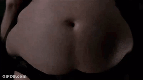 A Close Up Of A Woman 'S Belly With A Stomach Ache . GIF