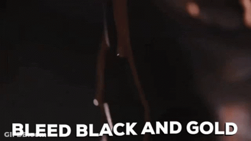 A Close Up Of A Woman 'S Breast With The Words Bleed Black And Gold Written On It . GIF