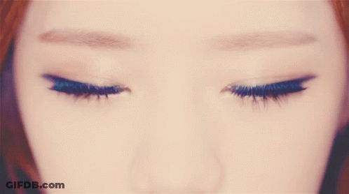 A Close Up Of A Woman 'S Brown Eyes With A Circle In The Middle GIF