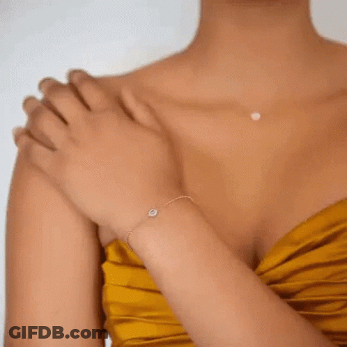 A Close Up Of A Woman 'S Ear With A Pair Of Gold Hoop Earrings GIF