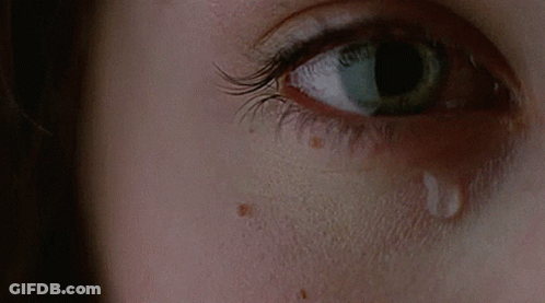 A Close Up Of A Woman 'S Eye With A Tear On It GIF