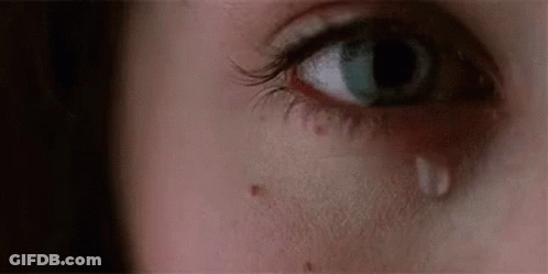 A Close Up Of A Woman 'S Eye With A Tear On It . GIF