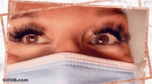 A Close Up Of A Woman 'S Eyes With A Mask On GIF