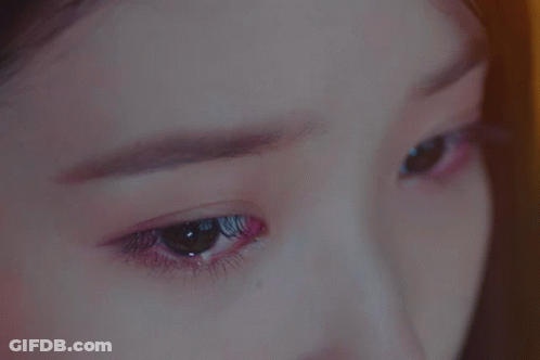 A Close Up Of A Woman 'S Eyes With A Purple Eyeshadow GIF