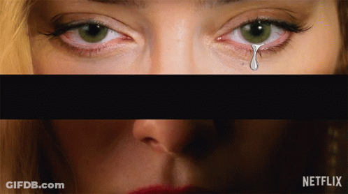A Close Up Of A Woman 'S Eyes With A Tear Coming Out Of It GIF