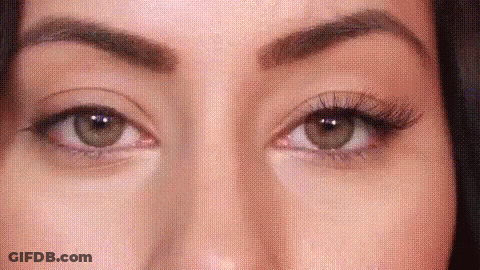 A Close Up Of A Woman 'S Eyes With False Eyelashes And Makeup . GIF