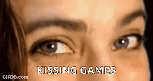 A Close Up Of A Woman 'S Eyes With The Words `` Kissing Games '' Written Above Them . GIF