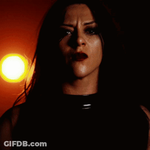 A Close Up Of A Woman 'S Face Against A Red Background GIF
