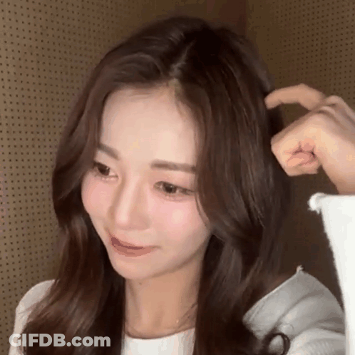 A Close Up Of A Woman 'S Face And Hair With A Person 'S Hand On It . GIF