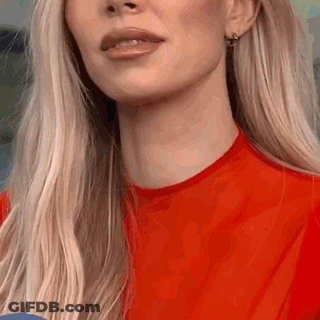 A Close Up Of A Woman 'S Face And Neck In A Red Shirt . GIF