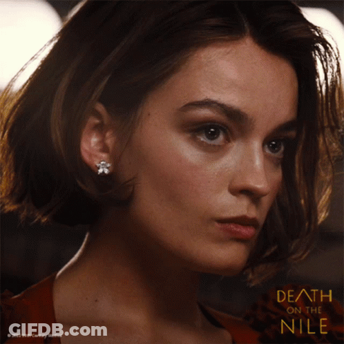 A Close Up Of A Woman 'S Face And The Words Death On The Nile GIF