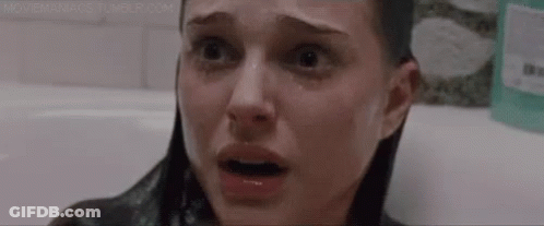 A Close Up Of A Woman 'S Face In A Bathtub With Her Eyes Closed And Tears Running Down Her Face . GIF