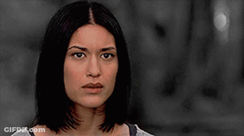 A Close Up Of A Woman 'S Face In A Black And White Photo . GIF