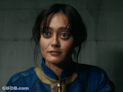 A Close Up Of A Woman 'S Face In A Blue Jacket GIF