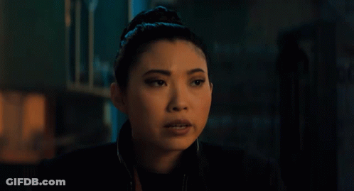 A Close Up Of A Woman 'S Face In A Dark Room GIF