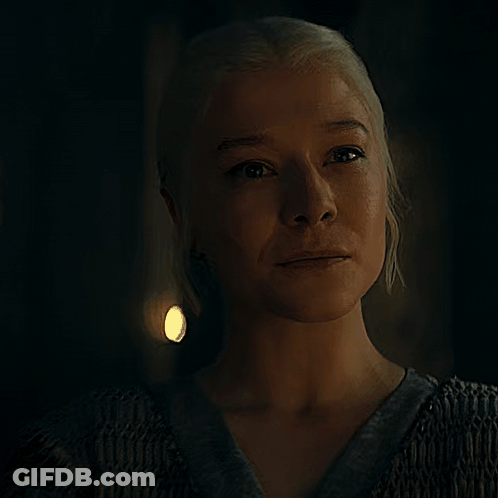 A Close Up Of A Woman 'S Face In A Dark Room GIF