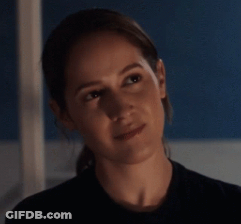 A Close Up Of A Woman 'S Face In A Dark Room . GIF