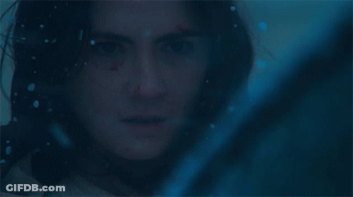 A Close Up Of A Woman 'S Face In A Dark Room GIF