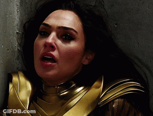 A Close Up Of A Woman 'S Face In A Gold Armor GIF