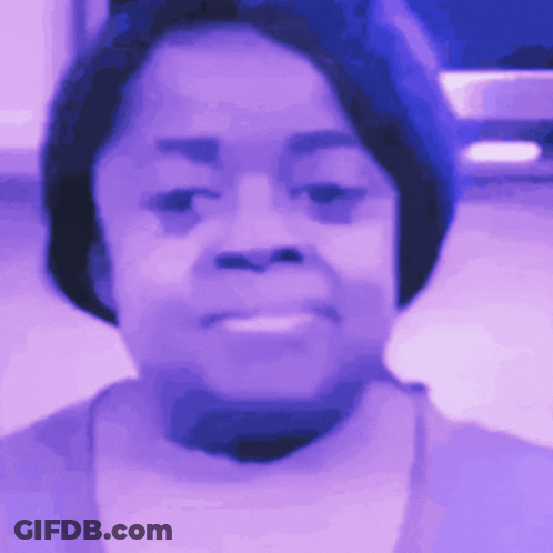 A Close Up Of A Woman 'S Face In A Purple Light GIF