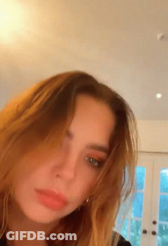 A Close Up Of A Woman 'S Face In A Room GIF