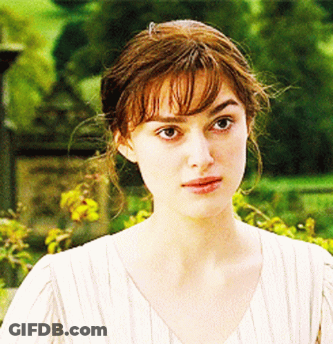 A Close Up Of A Woman 'S Face In A White Shirt GIF