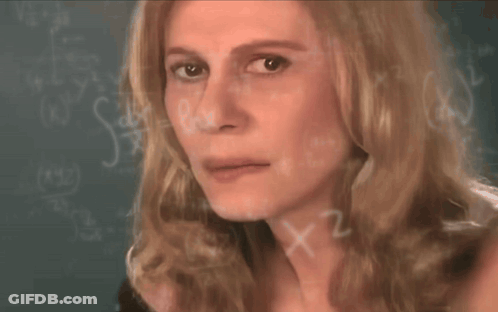 A Close Up Of A Woman 'S Face In Front Of A Blackboard With Math Equations GIF
