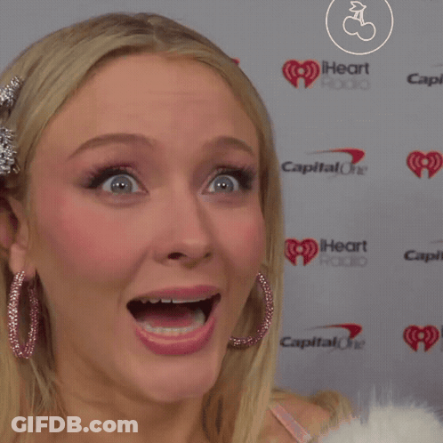 A Close Up Of A Woman 'S Face In Front Of A Capital One Logo GIF