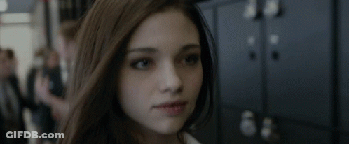 A Close Up Of A Woman 'S Face In Front Of A Row Of Lockers GIF