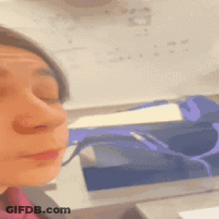 A Close Up Of A Woman 'S Face In Front Of A White Board With Numbers On It GIF