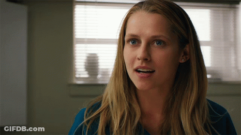A Close Up Of A Woman 'S Face In Front Of A Window With Blinds GIF