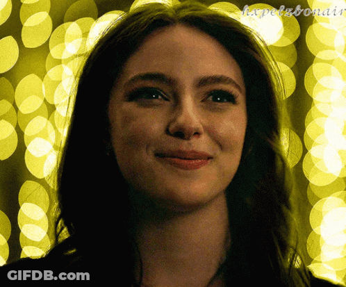 A Close Up Of A Woman 'S Face In Front Of A Yellow Background With The Letters H.x.pelzbonair GIF