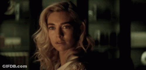A Close Up Of A Woman 'S Face In The Dark . GIF