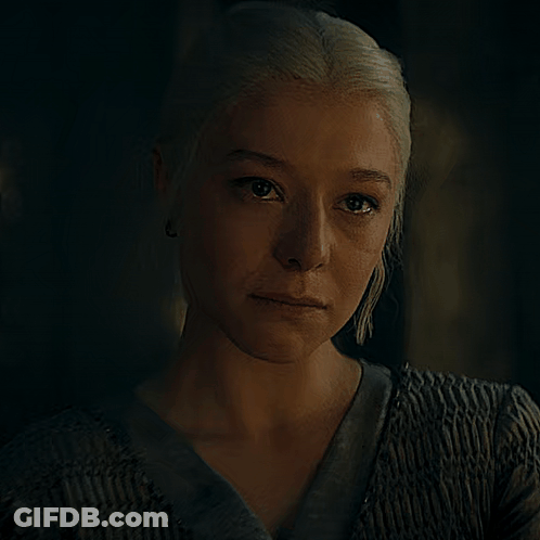 A Close Up Of A Woman 'S Face In The Dark GIF