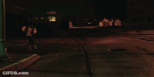 A Close Up Of A Woman 'S Face In The Dark GIF