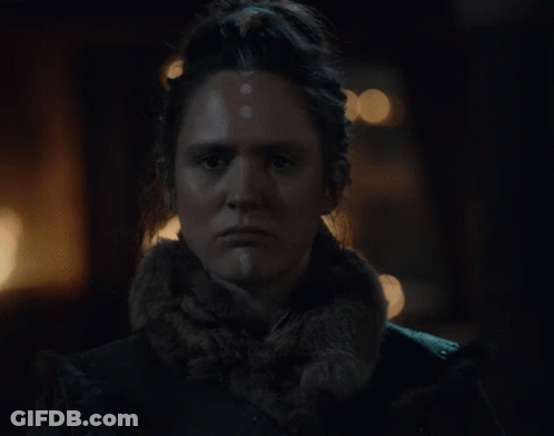 A Close Up Of A Woman 'S Face In The Dark GIF