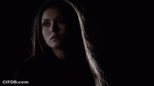 A Close Up Of A Woman 'S Face In The Dark With A Dark Background . GIF