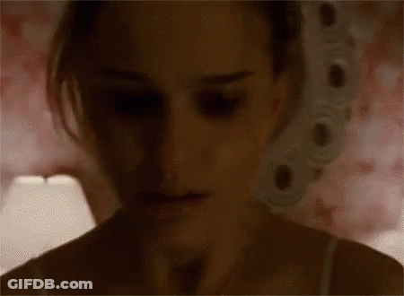 A Close Up Of A Woman 'S Face In The Dark With A Lamp In The Background . GIF
