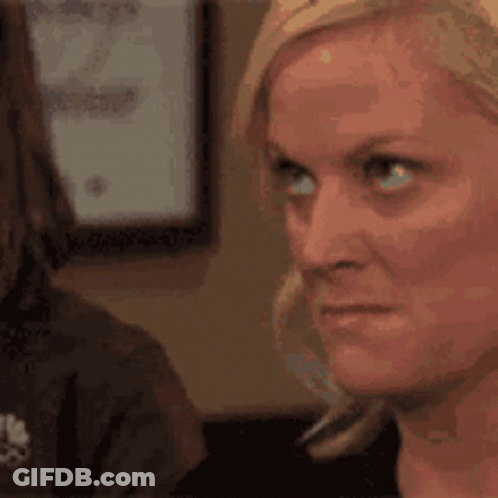 A Close Up Of A Woman 'S Face Looking At Another Woman . GIF