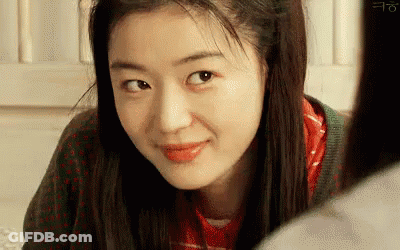 A Close Up Of A Woman 'S Face Looking At The Camera . GIF