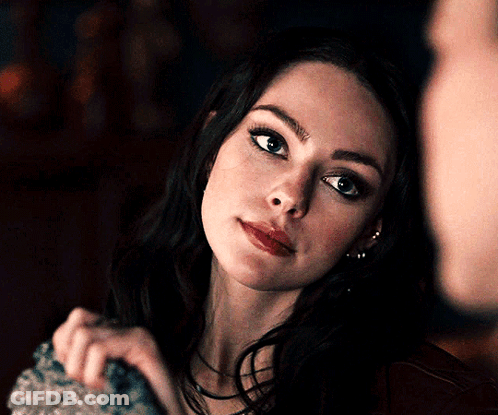 A Close Up Of A Woman 'S Face Looking At The Camera GIF