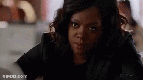 A Close Up Of A Woman 'S Face Looking At The Camera . GIF