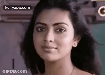A Close Up Of A Woman 'S Face Looking At The Camera With A Serious Look On Her Face . GIF