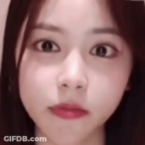 A Close Up Of A Woman 'S Face Making A Funny Face With Her Eyes Closed . GIF