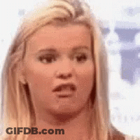 A Close Up Of A Woman 'S Face Making A Funny Face . GIF