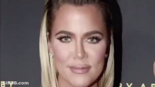 A Close Up Of A Woman 'S Face On A Red Carpet With A Black Background . GIF